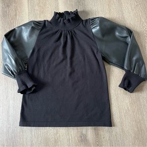 Siono Milano high neck ruffle sweater with faux leather puff sleeves.